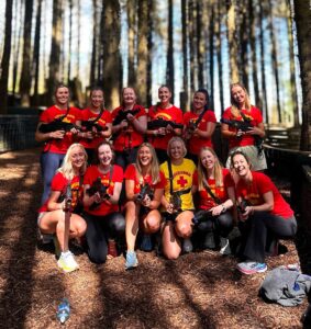 Laser tag for hen party. Hen party posing in an outdoor laser tag arena.